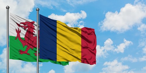 Wales and Chad flag waving in the wind against white cloudy blue sky together. Diplomacy concept, international relations.