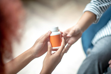 Female patient taking antidepressant while having psychoanalysis