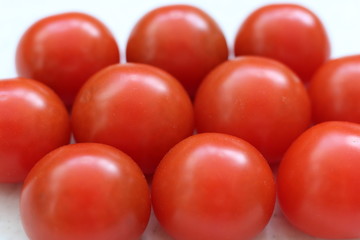 Red big tomatoes stack isolated on table.
