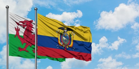 Wales and Ecuador flag waving in the wind against white cloudy blue sky together. Diplomacy concept, international relations.