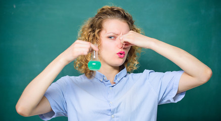 stench. girl hold chemical flask with liquid. student with beaker. scientist at school lab. school lesson. biology experiment. sample formula. chemistry research results