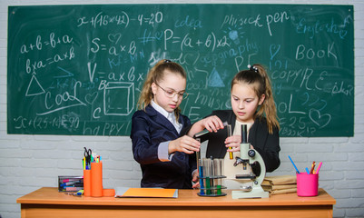 Chemistry research. Children using microscope. Little girls in school lab. Microscope. Biology lesson. Checking the results. Little scientist work with microscope. science experiments in laboratory