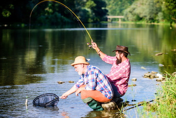 hunting. happy fishermen friendship. Catching and fishing. Two male friends fishing together....
