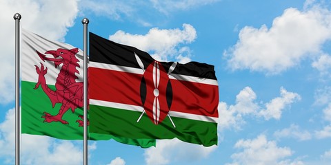 Wales and Kenya flag waving in the wind against white cloudy blue sky together. Diplomacy concept, international relations.