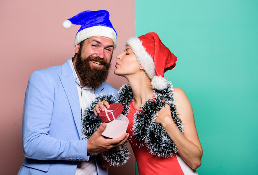 Christmas Party Office. Giving Gift. Festive Mood. Boxing Day. Secret Santa. Winter Corporate Party. Office Christmas Party. Happy Man And Woman Wear Santa Hats. Cheerful Couple Celebrate New Year