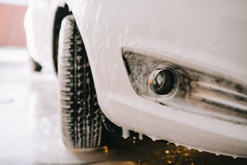White car at the sink in the foam