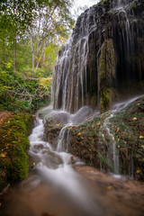 river with waterfall in the autumn season