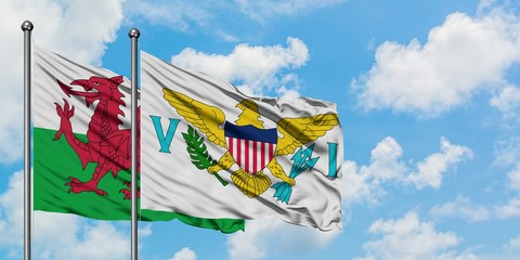 Wales and United States Virgin Islands flag waving in the wind against white cloudy blue sky together. Diplomacy concept, international relations.