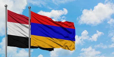 Yemen and Armenia flag waving in the wind against white cloudy blue sky together. Diplomacy concept, international relations.