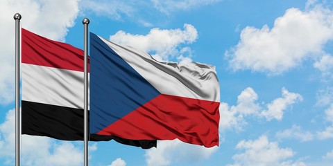 Yemen and Czech Republic flag waving in the wind against white cloudy blue sky together. Diplomacy concept, international relations.