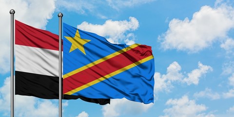 Yemen and Congo flag waving in the wind against white cloudy blue sky together. Diplomacy concept, international relations.