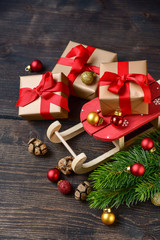 Christmas and New Year box gifts are packed in gold beige paper with red bows, green tree, shiny balls,  layout christmas 2020 and new year 2020 card concept