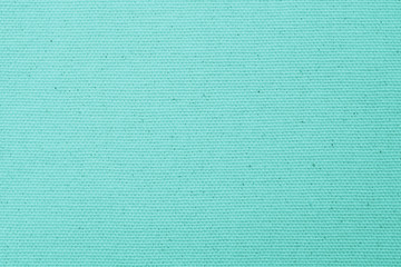 Hessian sackcloth woven texture pattern background in bleached turquoise cyan green color