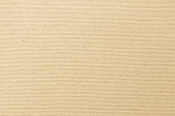 Hessian sackcloth woven texture pattern background in light yellow cream brown color