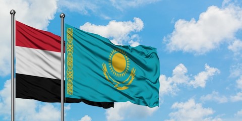 Yemen and Kazakhstan flag waving in the wind against white cloudy blue sky together. Diplomacy concept, international relations.