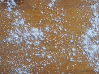 Flour on wooden background
