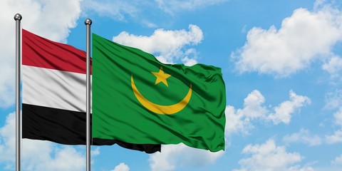 Yemen and Mauritania flag waving in the wind against white cloudy blue sky together. Diplomacy concept, international relations.