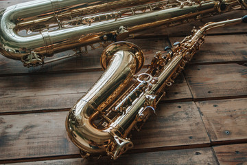 two saxophones on wooden background