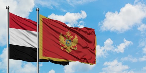 Yemen and Montenegro flag waving in the wind against white cloudy blue sky together. Diplomacy concept, international relations.