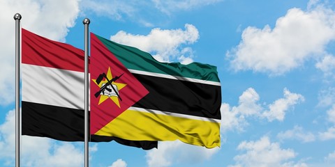Yemen and Mozambique flag waving in the wind against white cloudy blue sky together. Diplomacy concept, international relations.