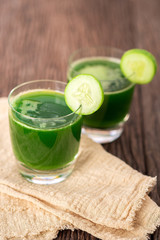 Cold cucumber soup with avocado and mint,Glass of cucumber juice on grey wooden background