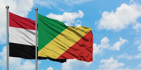Yemen and Republic Of The Congo flag waving in the wind against white cloudy blue sky together. Diplomacy concept, international relations.