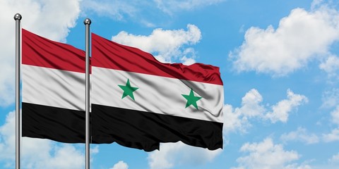 Yemen and Syria flag waving in the wind against white cloudy blue sky together. Diplomacy concept,...