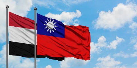 Yemen and Taiwan flag waving in the wind against white cloudy blue sky together. Diplomacy concept, international relations.