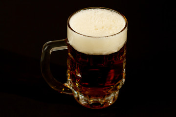 glass of beer isolated on black background