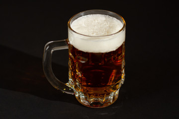 glass of beer isolated on black background