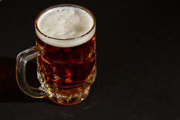 glass of beer on black background