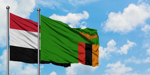 Yemen and Zambia flag waving in the wind against white cloudy blue sky together. Diplomacy concept, international relations.