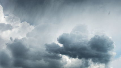 Storm clouds with stripes of rain from above