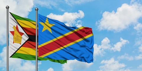 Zimbabwe and Congo flag waving in the wind against white cloudy blue sky together. Diplomacy concept, international relations.