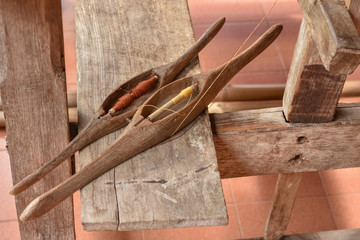 Weaving shuttles on  wooden seat of the loom. Traditional design wooden shuttles.