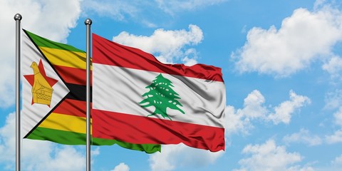 Zimbabwe and Lebanon flag waving in the wind against white cloudy blue sky together. Diplomacy concept, international relations.