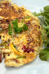 omelette with peppers and bacon on a plate