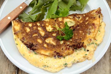 herbed omelette and bacon on a plate