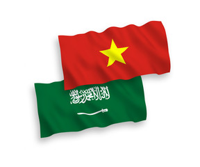 National vector fabric wave flags of Saudi Arabia and Vietnam isolated on white background. 1 to 2 proportion.