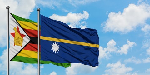 Zimbabwe and Nauru flag waving in the wind against white cloudy blue sky together. Diplomacy concept, international relations.