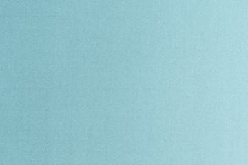 Authentic fine Thai silk fabric textile detailed background in light pale blue green teal color tone