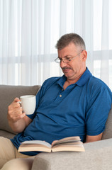 Fototapeta premium middle aged man reading a book