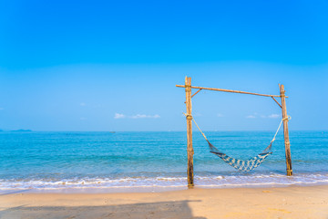 Empty hammock swing on the beautiful beach and sea