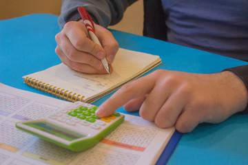 man working on office desk with Calculator. Man hand with calculator