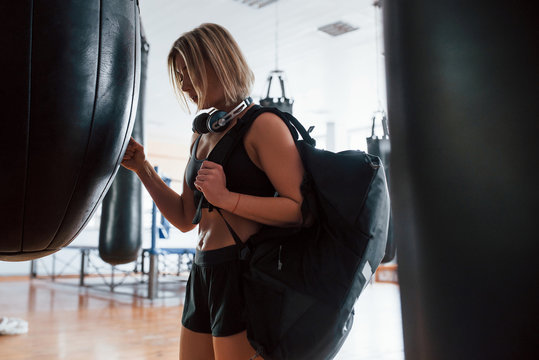 Can Go Home Now. Adult Female With Black Bag And Headphones In The Training Gym