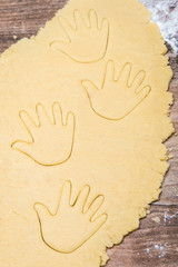 cookie dough with cutout hand shapes, concept baby is coming