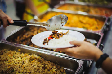 Volunteers provide free food to the poor with care : concept of begging for food