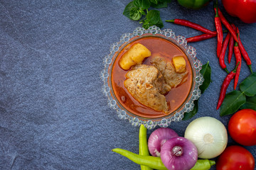 Asian food such as Thai red curry top view with copy space.Vegetables and ingredient are around in good cuisine design on the stone background.