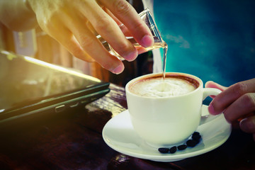pouring syrup in to Latte hot coffee cup