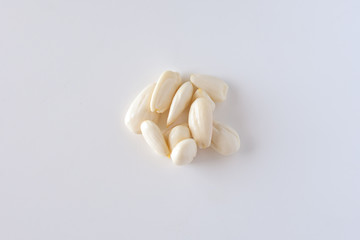 row, line of peeled young almonds on a white background, isolate, nut antioxidant